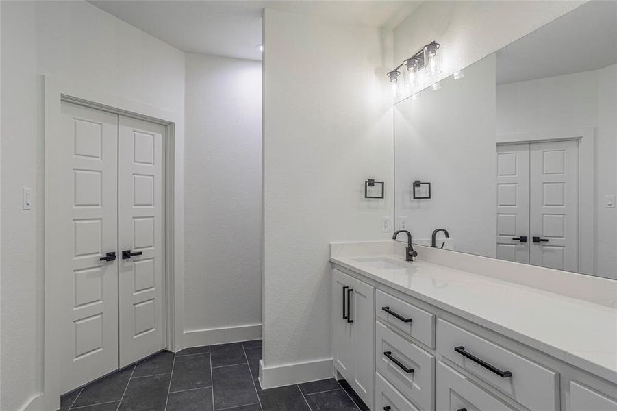 Bathroom featuring vanity and tile patterned flooring