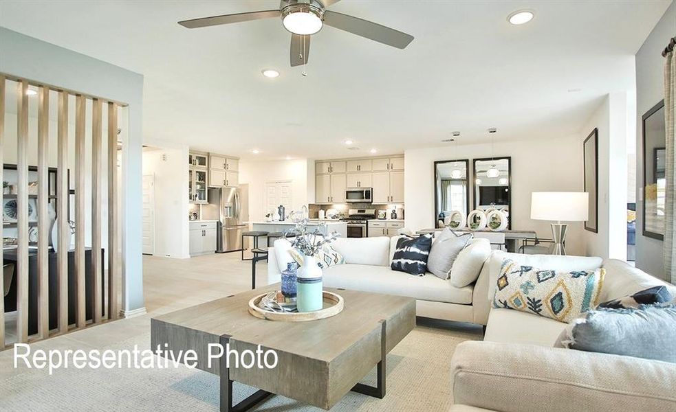 Living room featuring ceiling fan and light hardwood / wood-style flooring