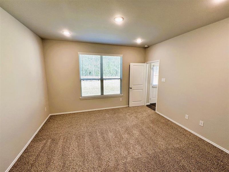 Natural light floods the master bedroom