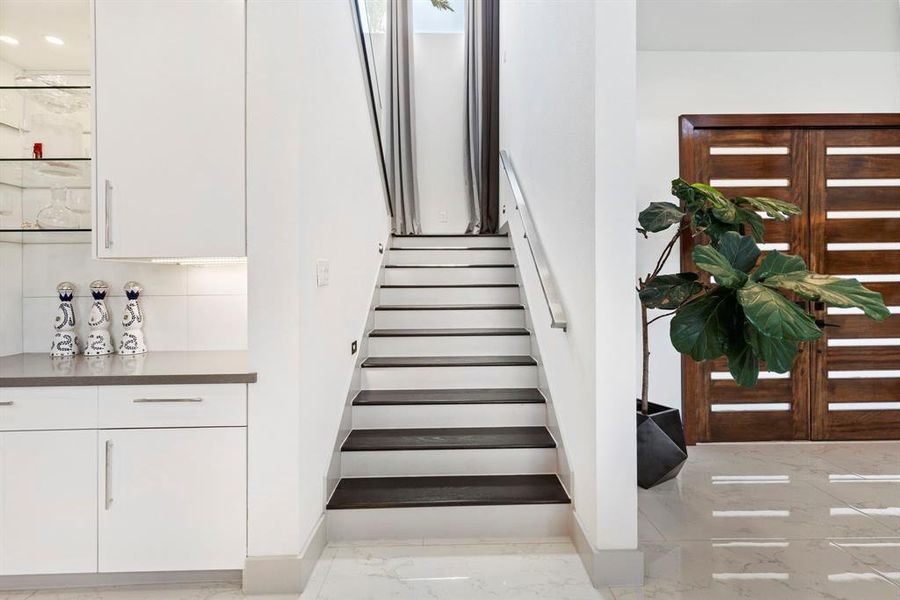 Elevating the home's aesthetics, the staircase is sleek with engineered wood treads and modern stainless steel rail.