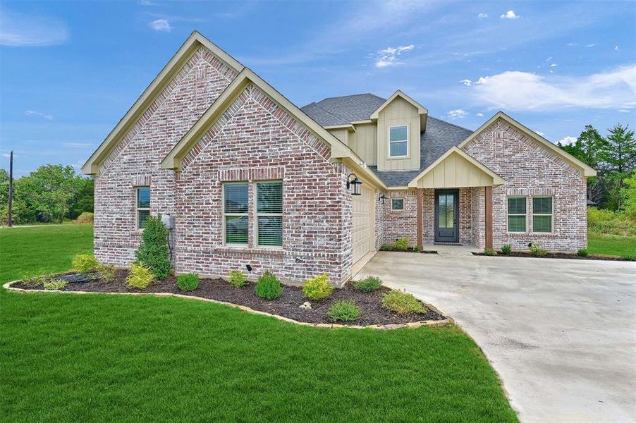 View of front of property with a front lawn