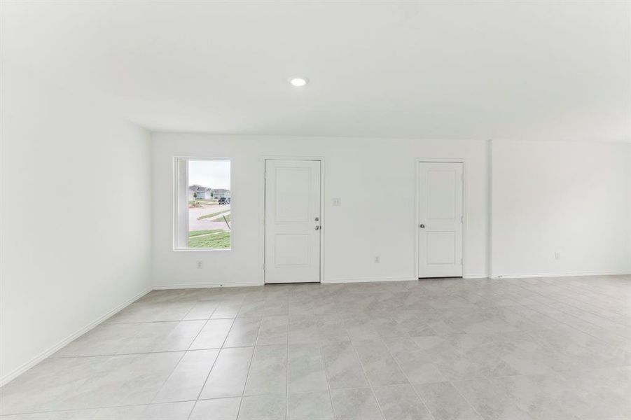Empty room with light tile patterned floors