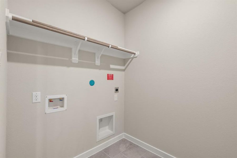 Laundry Room boasts built in shelving and hanging bar to help make laundry day a breeze!