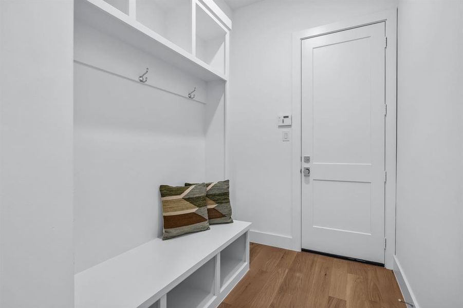 Mudroom with light hardwood / wood-style flooring