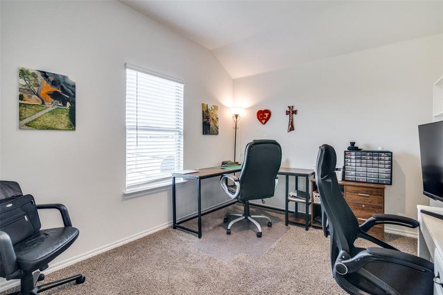 Office area featuring light colored carpet and lofted ceiling