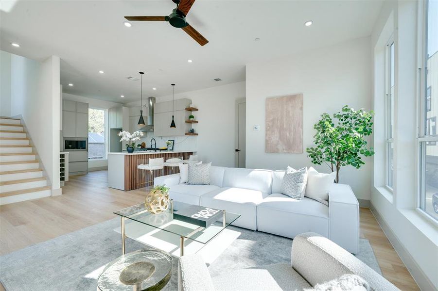 Living room with light wood-type flooring and ceiling fan