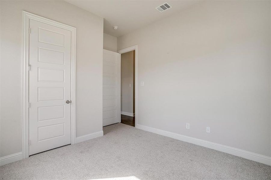 Unfurnished bedroom with carpet flooring