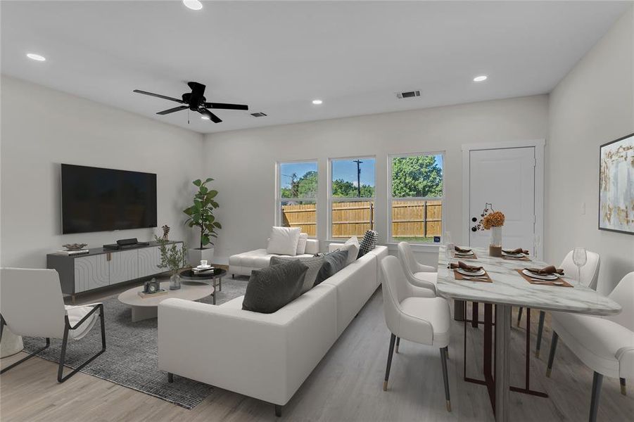 Living room featuring ceiling fan and light hardwood / wood-style flooring