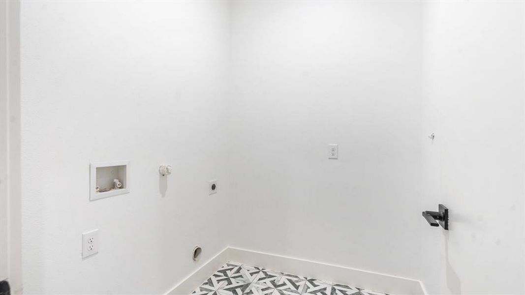 Washroom featuring electric dryer hookup, tile flooring, hookup for a gas dryer, and washer hookup