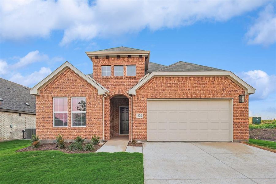 View of front property with a garage, central AC unit, and a front yard