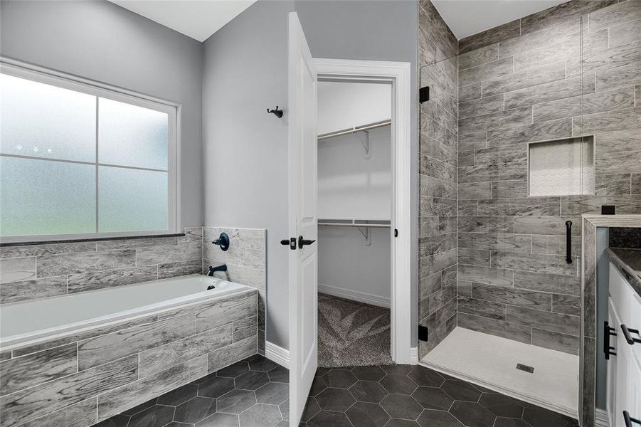 Bathroom with tile floors and separate shower and tub