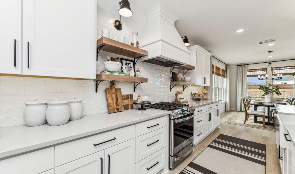 Kitchen with floating shelves and pendant lights