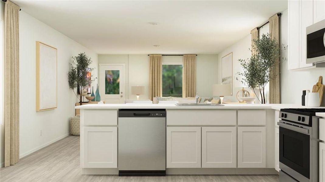 Kitchen with light hardwood / wood-style flooring, stainless steel appliances, sink, and white cabinetry