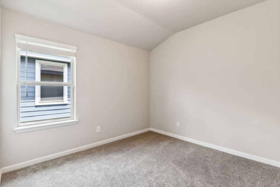 Guest bedroom in the Hughes floorplan at a Meritage Homes community.