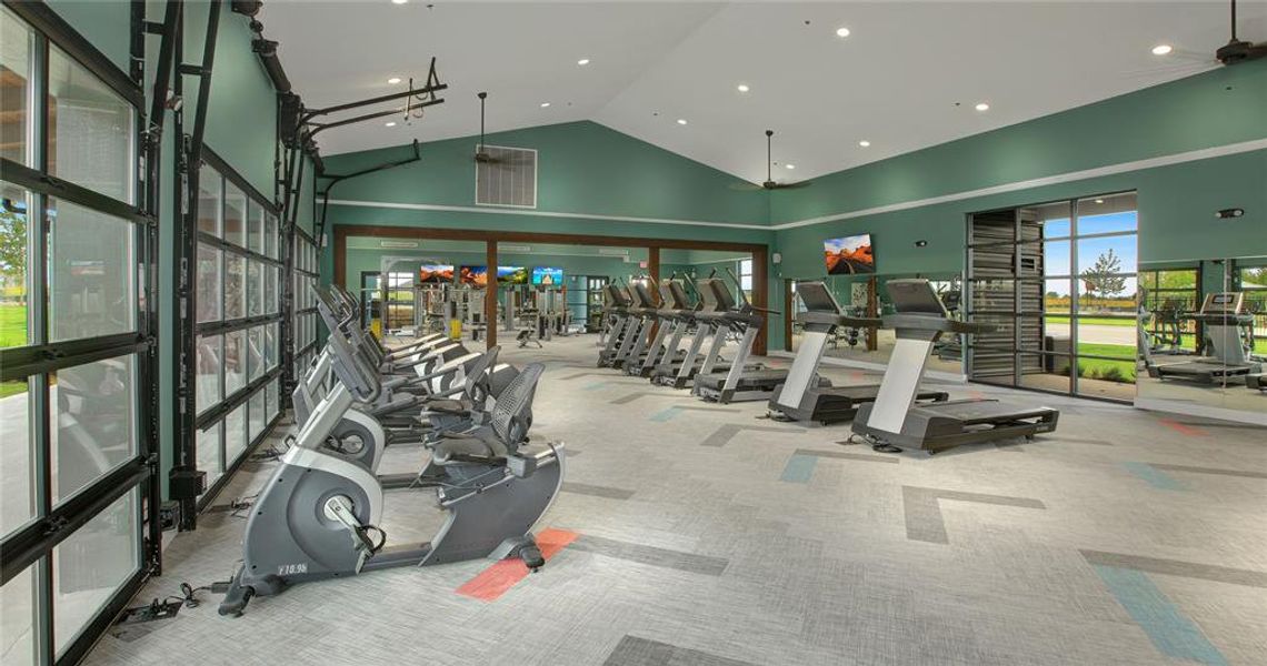 Neighborhood Gym featuring high vaulted ceiling and carpet floors