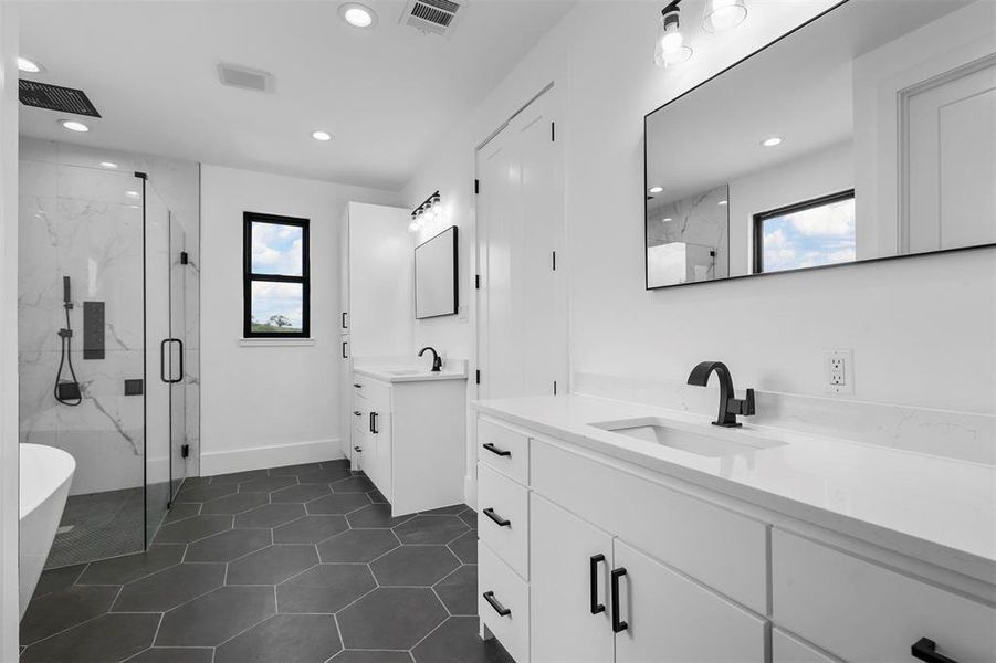 Bathroom with double vanity, plus walk in shower, and tile patterned floors