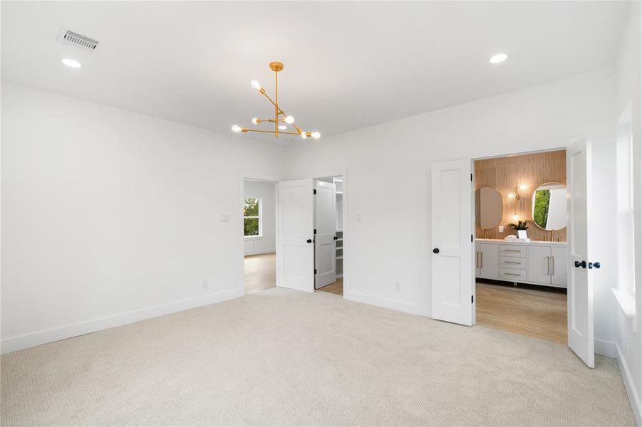 This bedroom offers spa-like bathroom and walk-in custom closet