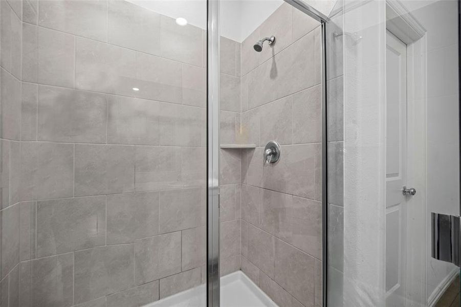 Bathroom with a shower with door