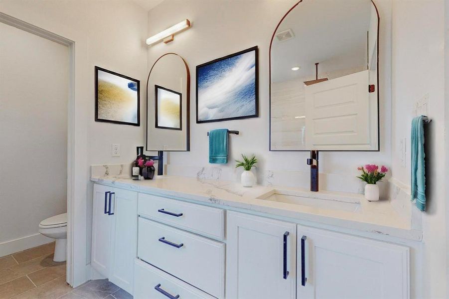 Staged Main Bathroom Bathroom with tile patterned flooring, dual vanity, and toilet