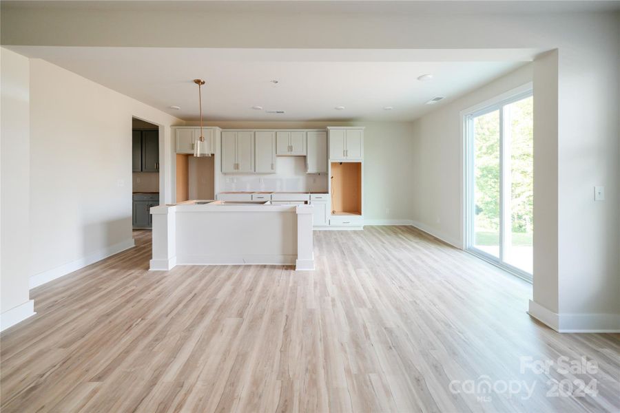 Gourmet kitchen with double wall ovens and gas cooktop.