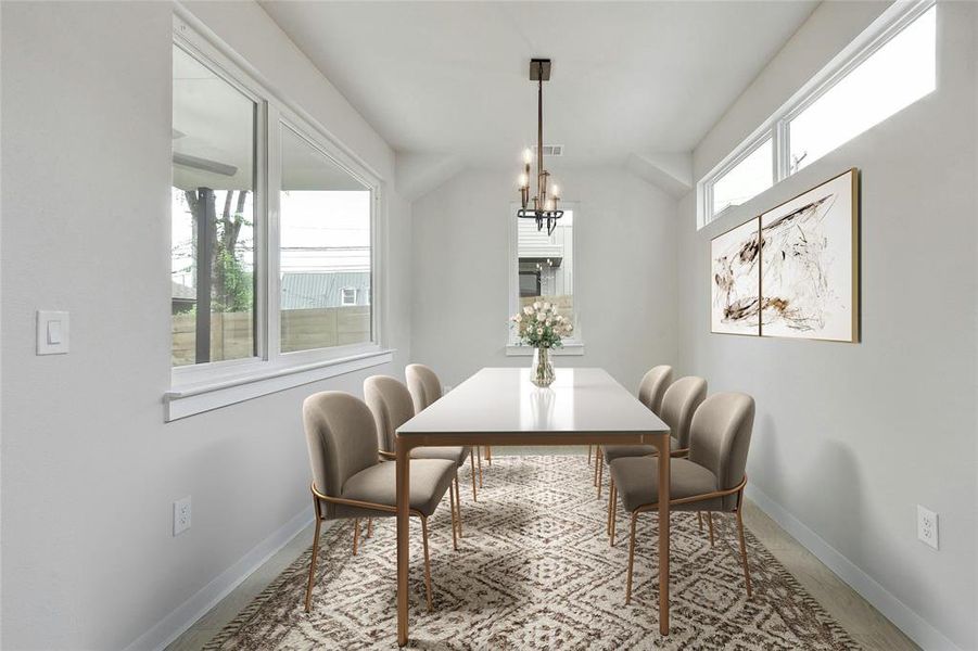A stunning chandelier adds a touch of elegance and sophistication to the dining space, making it a focal point for gatherings. *Virtually Staged*