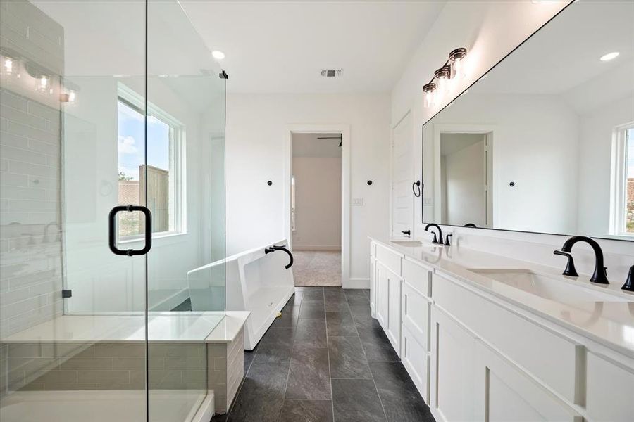 Bathroom with tile patterned floors, plus walk in shower, and dual bowl vanity