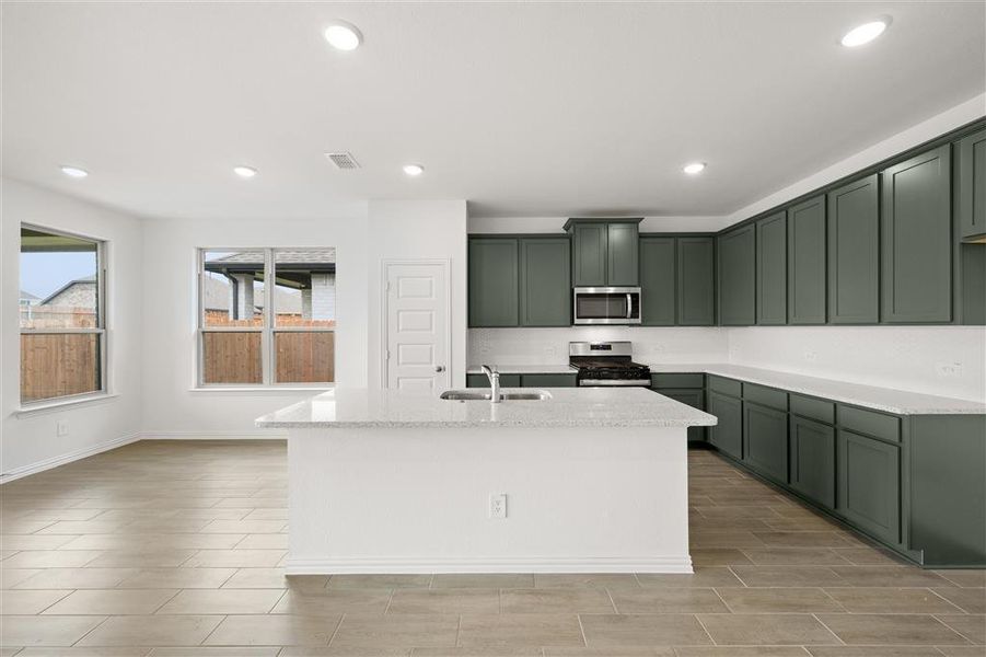 Kitchen w/ Granite Countertops and Tile Backsplash