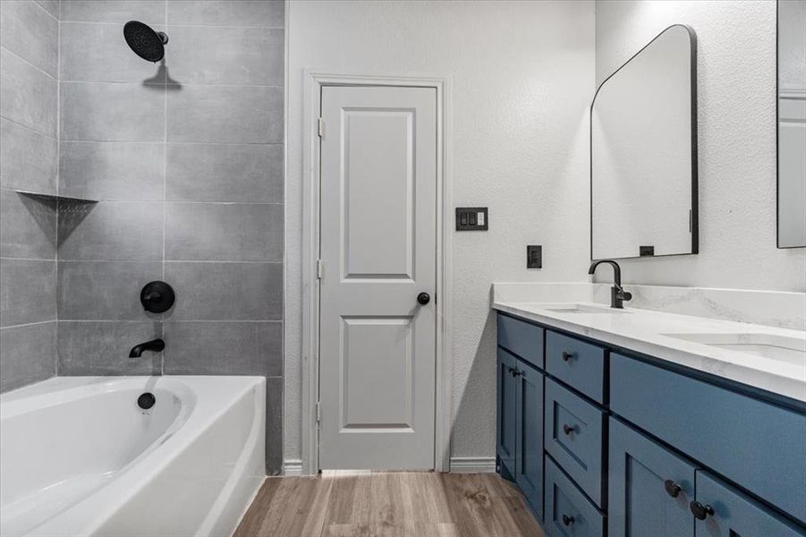 Bathroom featuring hardwood / wood-style flooring and double sink vanity