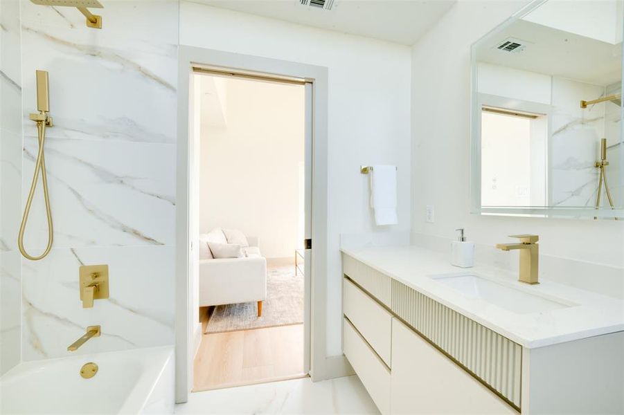 Bathroom with vanity, shower / bath combination, and hardwood / wood-style floors