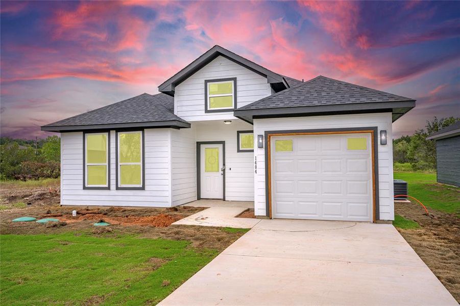 View of front facade featuring a garage and cooling unit