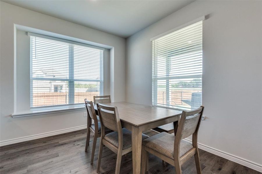 Dining area with dark wood-type flooring