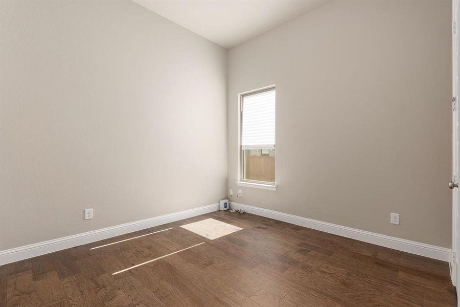 Spare room with dark hardwood / wood-style flooring