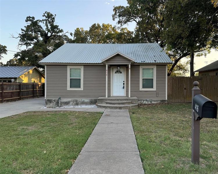 Bungalow with a front lawn