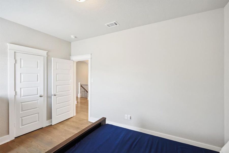 Unfurnished bedroom featuring hardwood / wood-style flooring