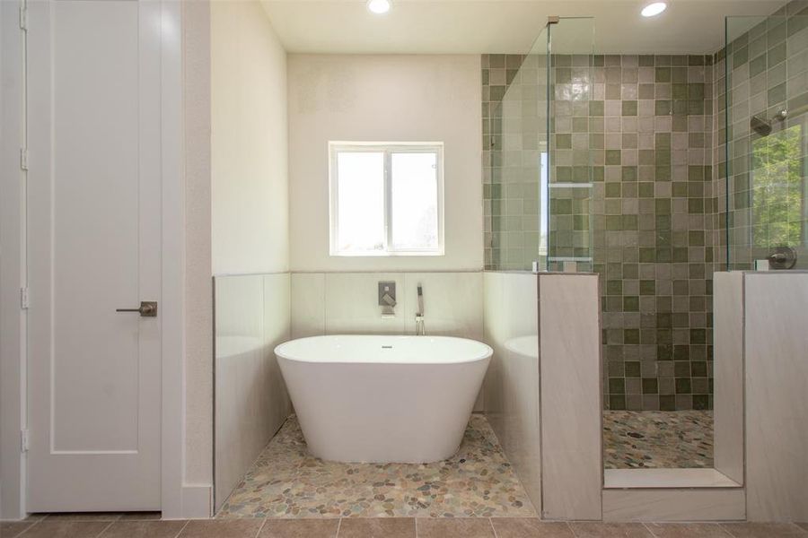 Bathroom with independent shower and bath and tile patterned floors