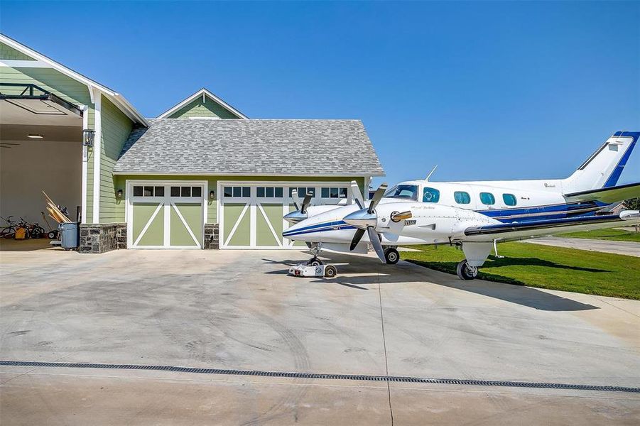 The home offers a 3-car garage and an expansive 50x40 airplane hangar with epoxy flooring, spray foam insulation, and a high-powered hangar door and tornado shelter.