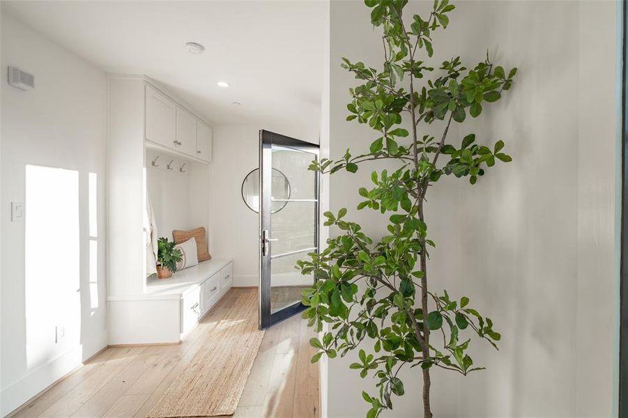 Mudroom featuring light wood flooring and cubbies