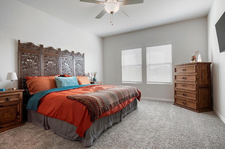 Bedroom featuring light colored carpet and ceiling fan