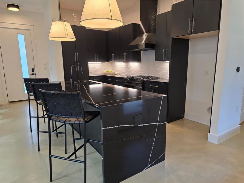 Awesome looking Eternal Noir Silestone kitchen island with waterfall effect on the sides. Space for a full size 36" refrigerator as well.