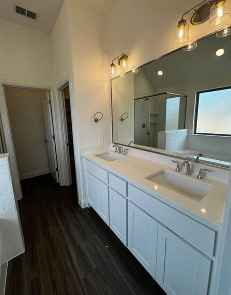 Bathroom with wood-type flooring, separate shower and tub, and vanity