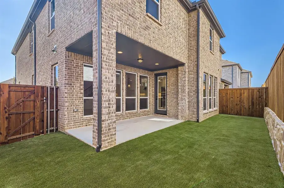 Back of house featuring a patio and a lawn