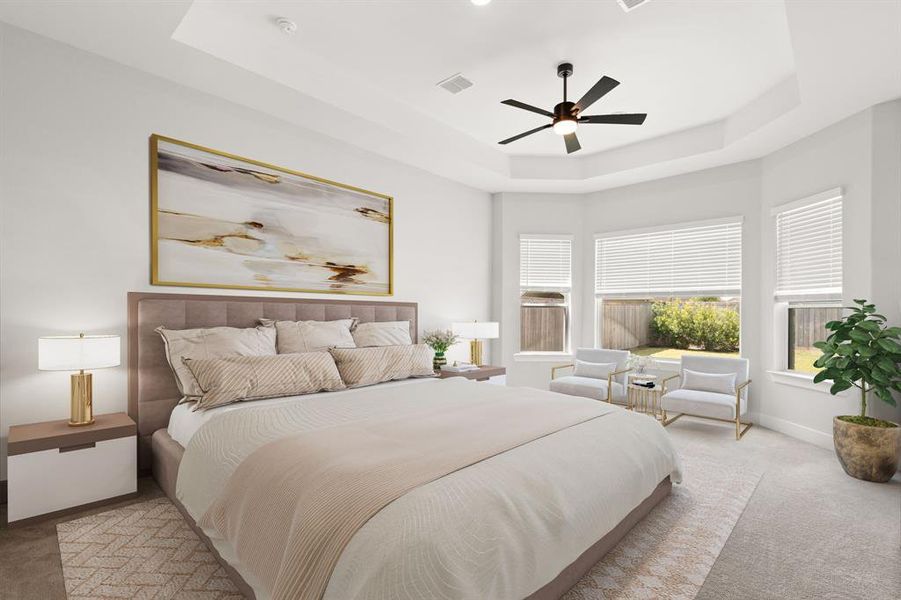 The primary bedroom boasts a tray ceiling, three windows for natural light, and plush carpeting, creating a spacious and inviting retreat.*Virtually Staged*