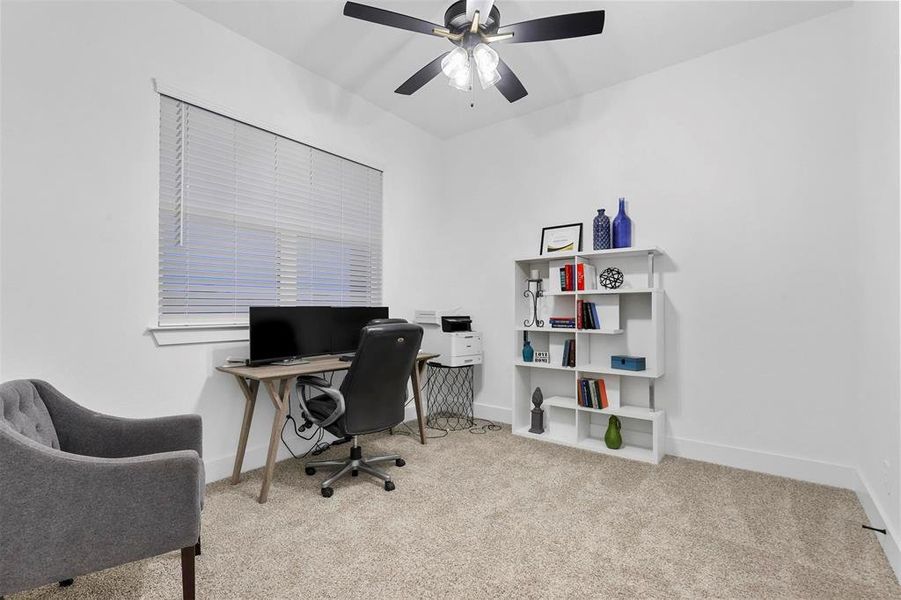 Carpeted office with ceiling fan