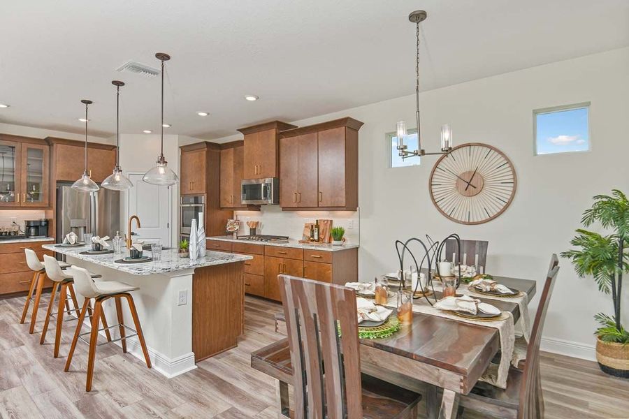 Sandalwood new home plan kitchen and dining area at Tea Olive Terrace by William Ryan Homes Tampa