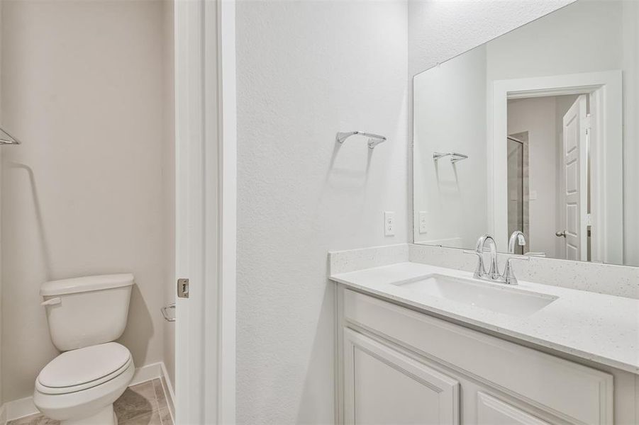 This is a clean and modern bathroom featuring a large vanity with a sink and a spacious mirror.