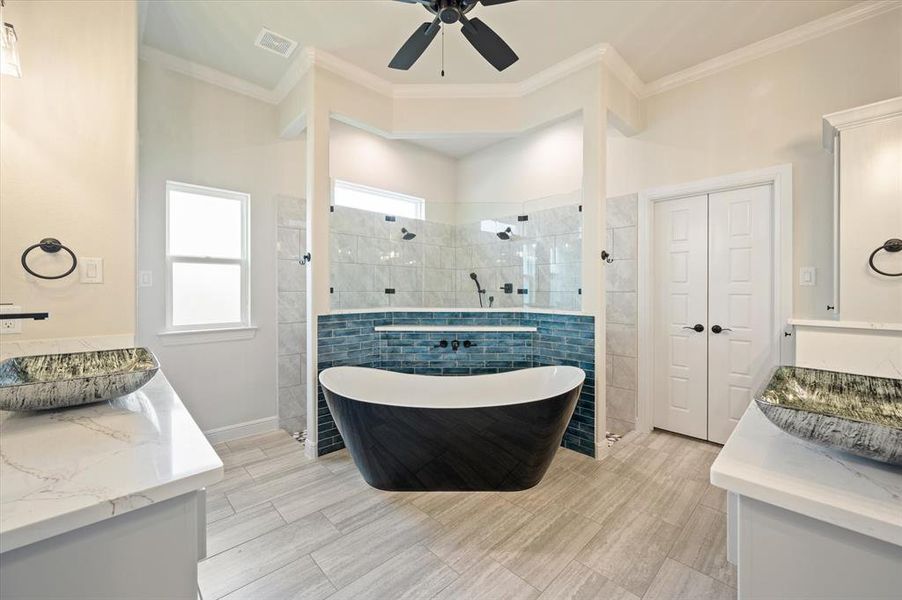 Bathroom with tile walls, tile patterned floors, vanity, ceiling fan, and ornamental molding