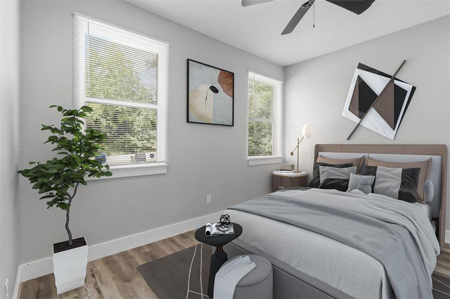 Bedroom with hardwood / wood-style floors and ceiling fan