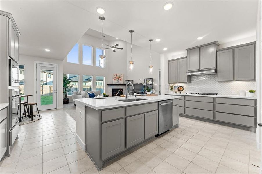 Abundant cabinets provide ample storage, while an elegant backsplash adds a touch of sophistication.