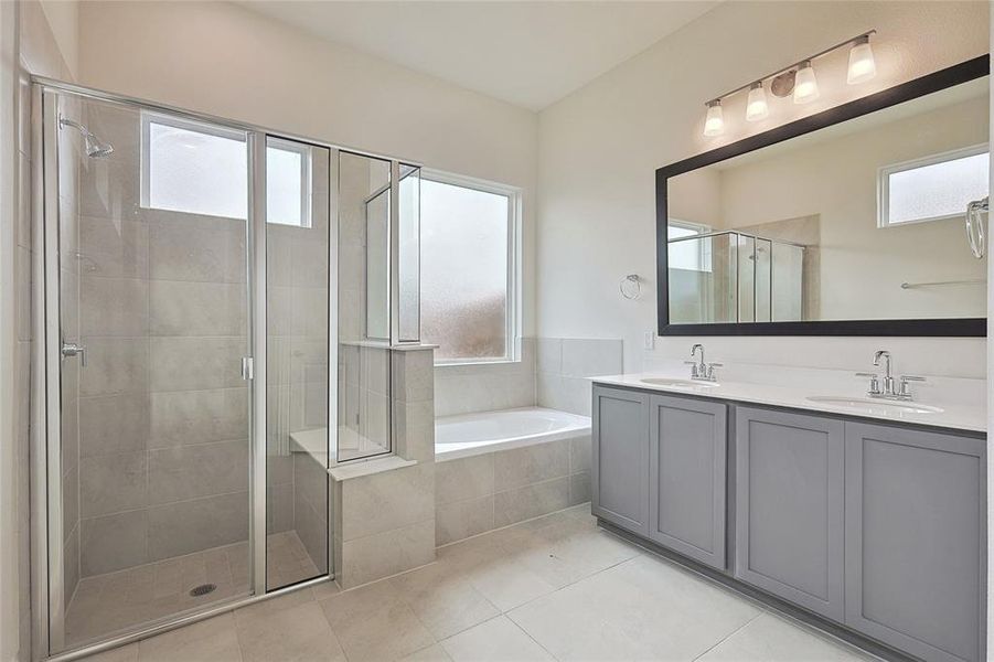 Bathroom featuring vanity, tile patterned floors, and independent shower and bath