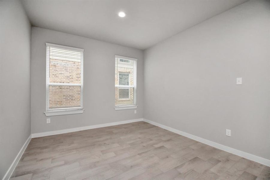 Craft enduring memories with loved ones around the table in this roomy dining area. It boasts stylish flooring, personalized paint, and is conveniently situated next to the family room and kitchen, fostering an open and inclusive ambiance.